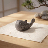 Aged gray cast iron pufferfish paperweight on a tabletop with coastal styling, SKU GB78104