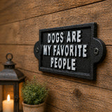 Angled black cast iron wall sign with white lettering.