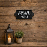 Small black cast iron wall sign with white lettering.