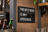 'The best beer is an open beer' cast iron wall bottle opener sign on a wood plank home bar wall