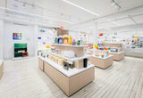 Modern gift and home store interior with lit display tables and wall shelves