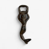 Cast iron mermaid bottle opener side angle showcasing curved tail and distressed rustic finish