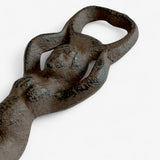 Detailed close-up of cast iron mermaid bottle opener showing textured tail and aged brown patina