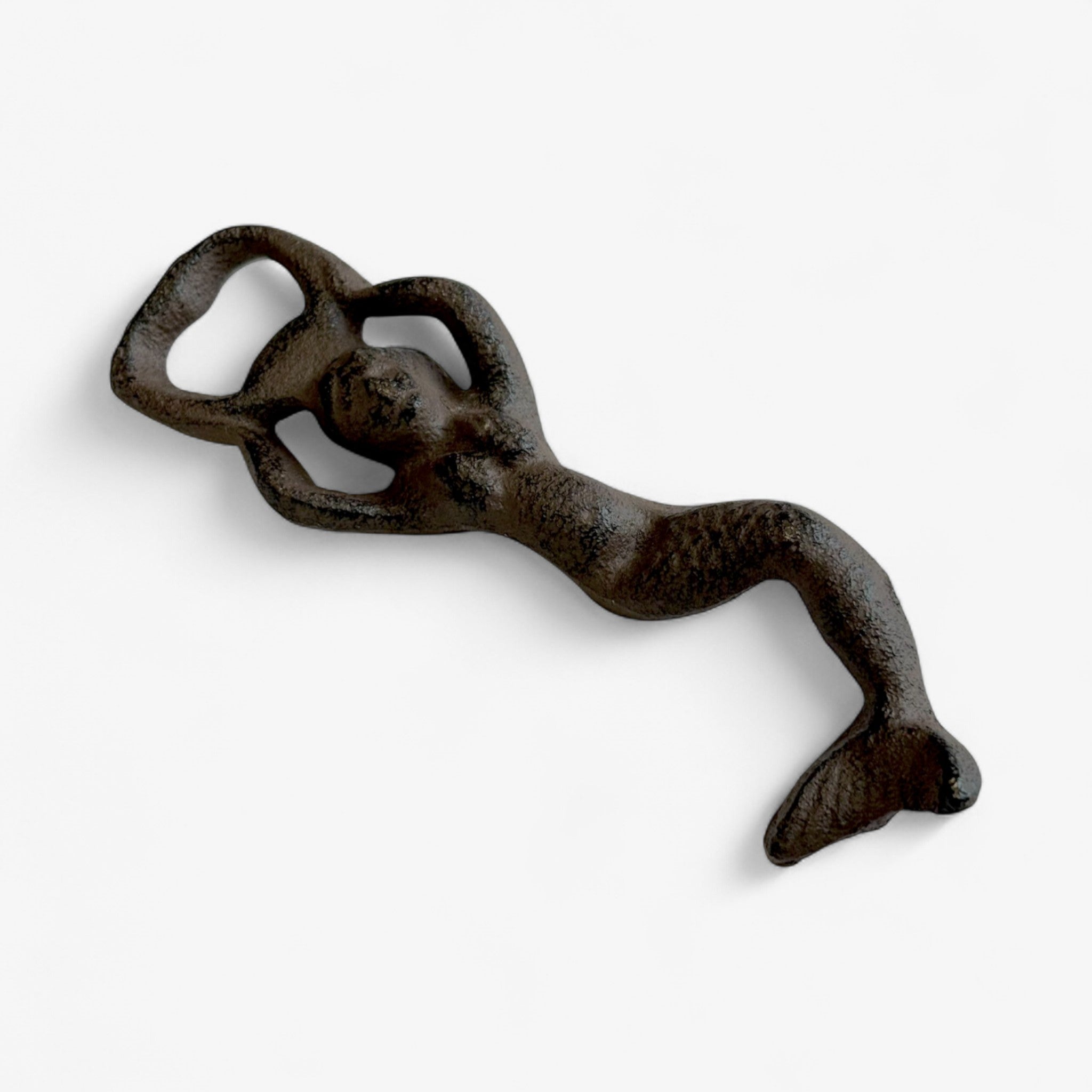 Full-body cast iron mermaid bottle opener in antique finish with decorative detail lying flat