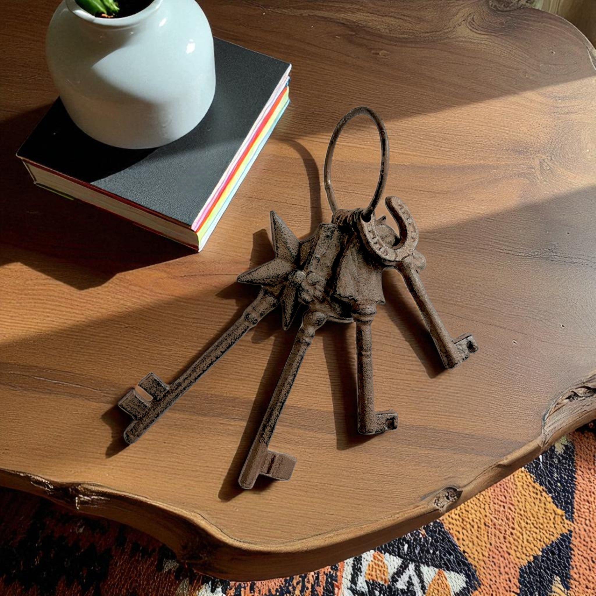 Antique cast iron key set with ring in rustic finish, displayed on wood desk with lifestyle decor