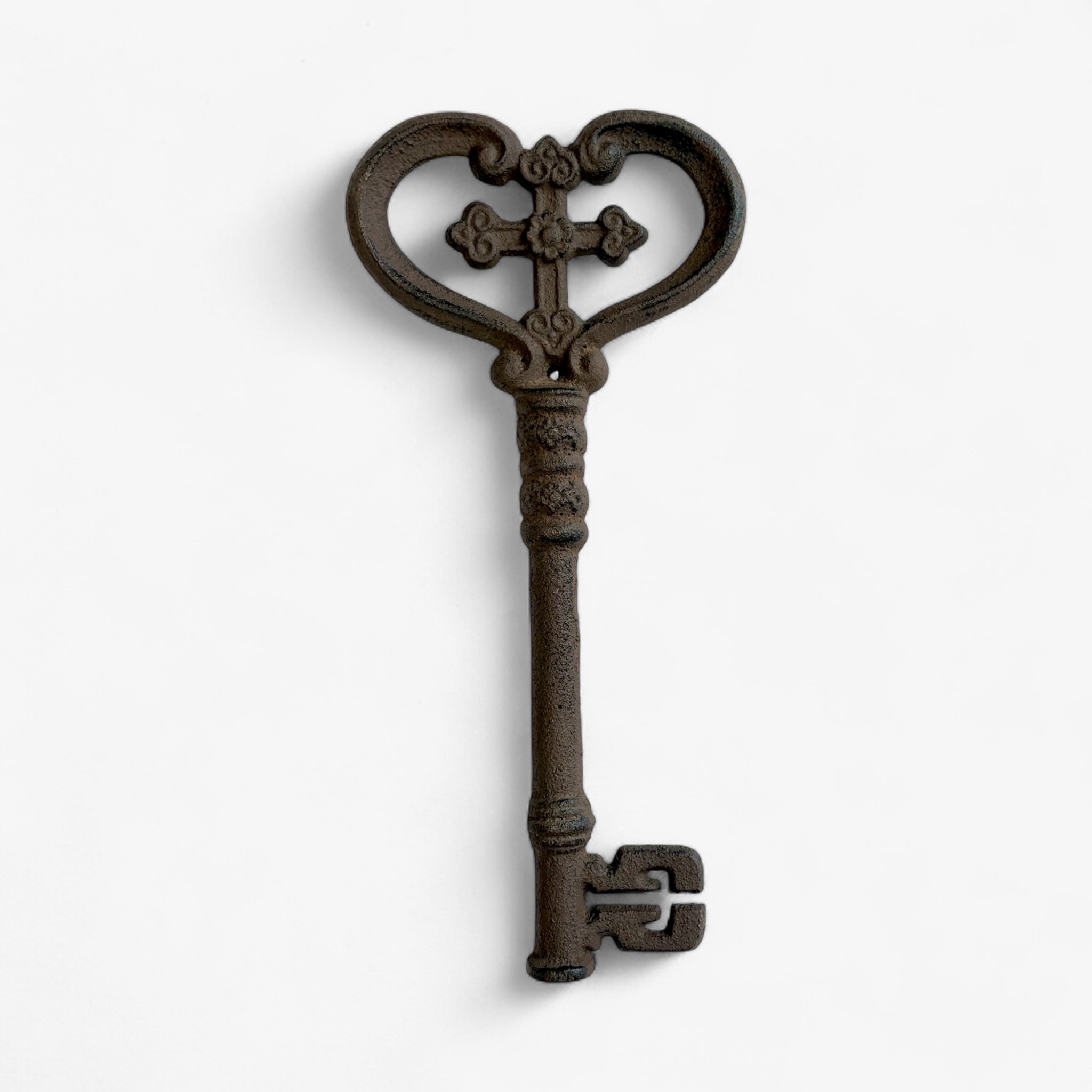 Bronze cast iron decorative key with detailed cross motif and textured shaft