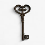 Bronze cast iron decorative key with detailed cross motif and textured shaft