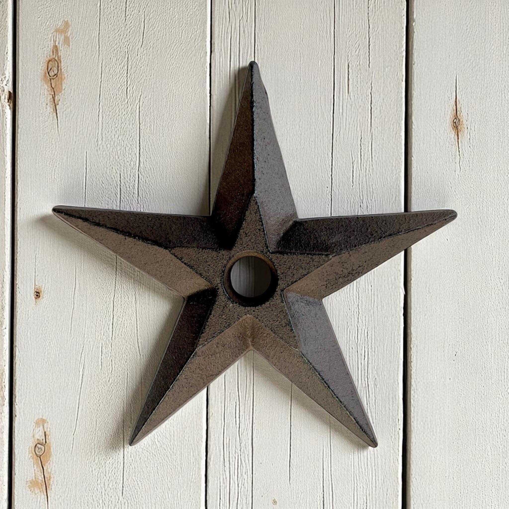 Rustic cast iron star wall decor with dark patina finish, vintage western accent on white shiplap