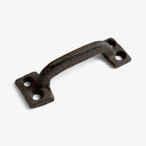 Curved rustic cast iron drawer handle with dual mounting holes and aged metal patina