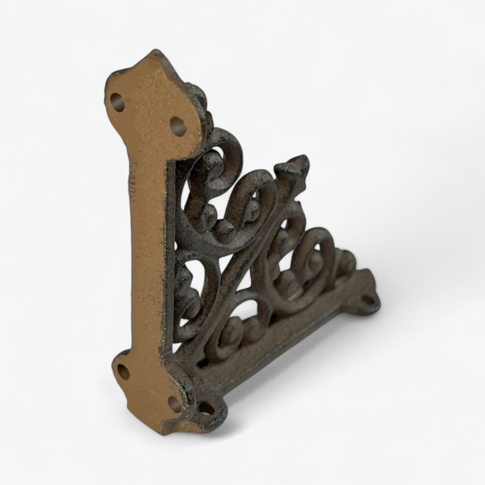 Cast iron scroll bracket angled view, intricate swirl pattern with bronze patina