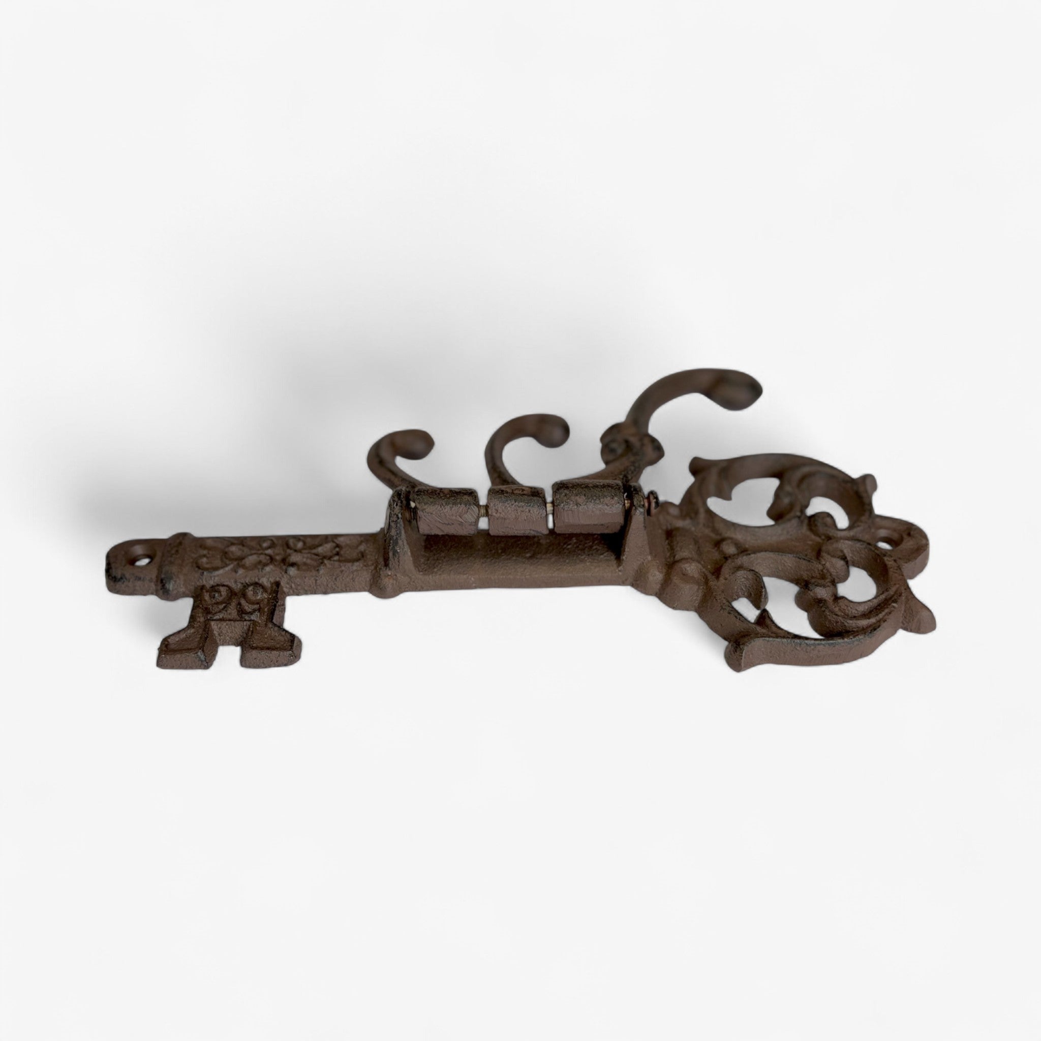 Antique dark brown cast iron skeleton key hook with decorative crown top and scrolled hooks