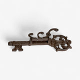 Antique dark brown cast iron skeleton key hook with decorative crown top and scrolled hooks