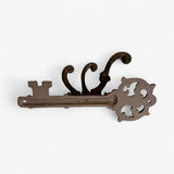 Cast iron skeleton key wall mount with ornate crown and twin curved hooks, aged brown finish