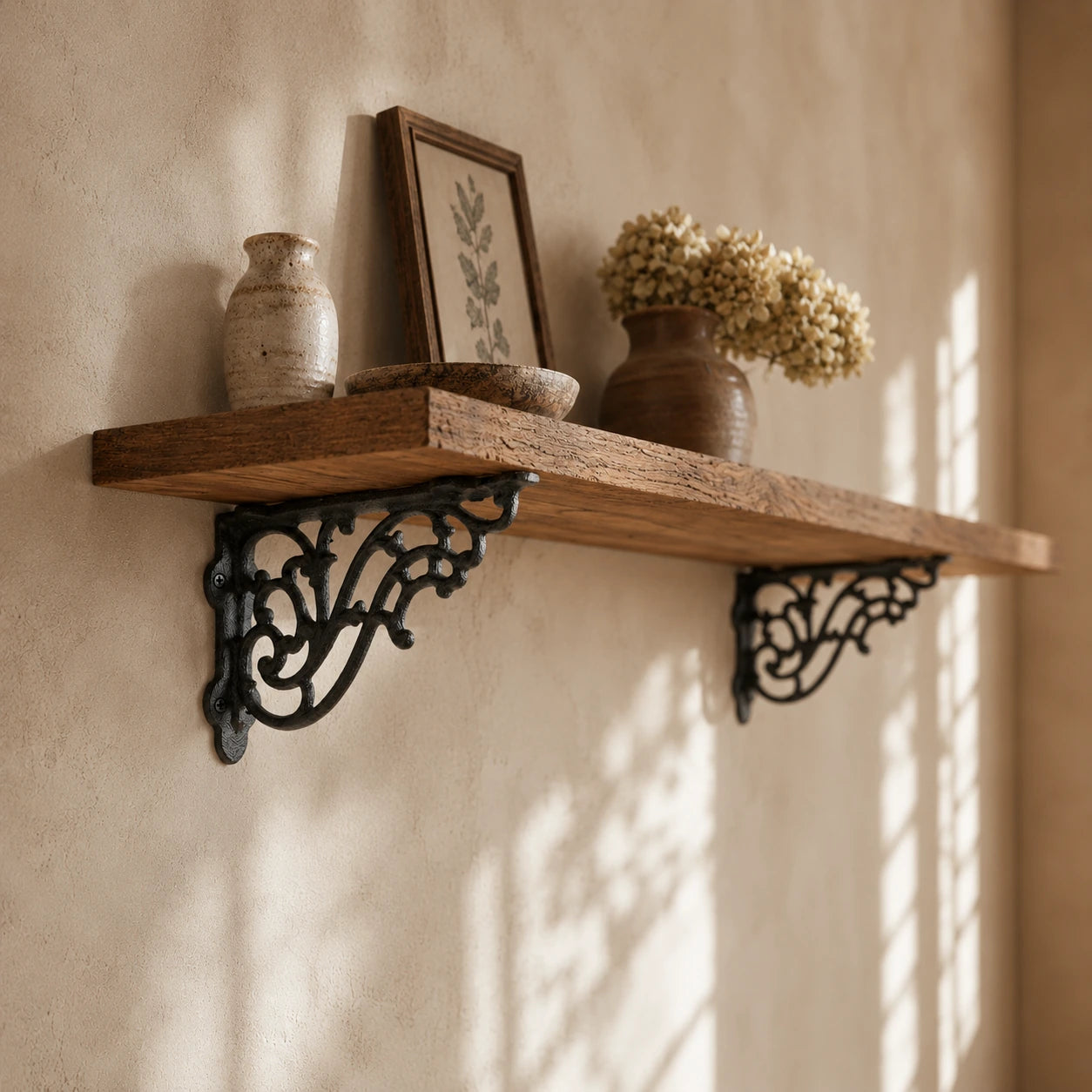 Rustic wood wall shelf with black cast iron brackets and decorative vases
