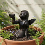 Black cast iron garden fairy statue with arms raised in celebratory pose