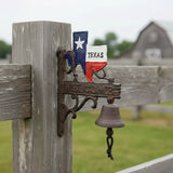 Rustic cast iron Texas welcome bell with ornate brackets, dark brown weathered finish