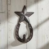 Cast iron star hook wall hanger with horseshoe base, dark finish, rustic western decor