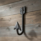 Black cast iron arrow head hook with decorative feathered shaft detail and curved holding hook