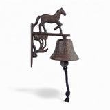 Vintage cast iron horse wall bell showing running pony silhouette detail, oxidized finish
