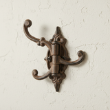 Rustic brown cast iron triple tier hook organizer with ornamental scrollwork design