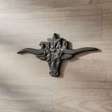 Black cast iron Texas longhorn wall decor with wide horns, rustic ranch style accent
