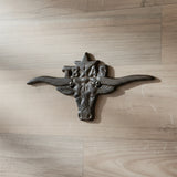 Black cast iron Texas longhorn wall decor with wide horns, rustic ranch style accent