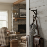 Rustic cast iron farmhouse hook with ornamental scroll design, dark brown finish on shiplap wall