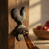 Black cast iron rooster bottle opener with detailed feather texture and curved handle