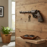 Western cast iron revolver wall hook with 4 keys hanging, mounted on wooden shiplap wall