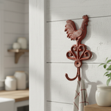 Red cast iron rooster hook with ornate base, rustic farmhouse kitchen decor