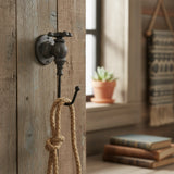 Black cast iron faucet hook with rope, industrial farmhouse wall accent in rustic decor