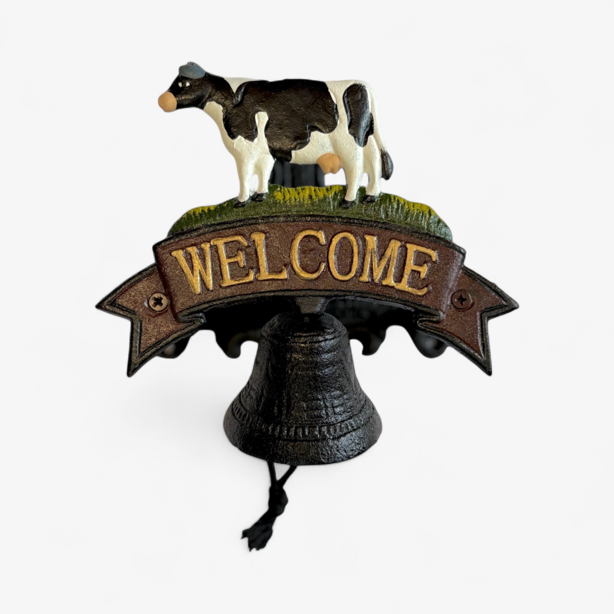 Full cast iron cow welcome bell sign with detailed black and white cow, green moss, and working bell