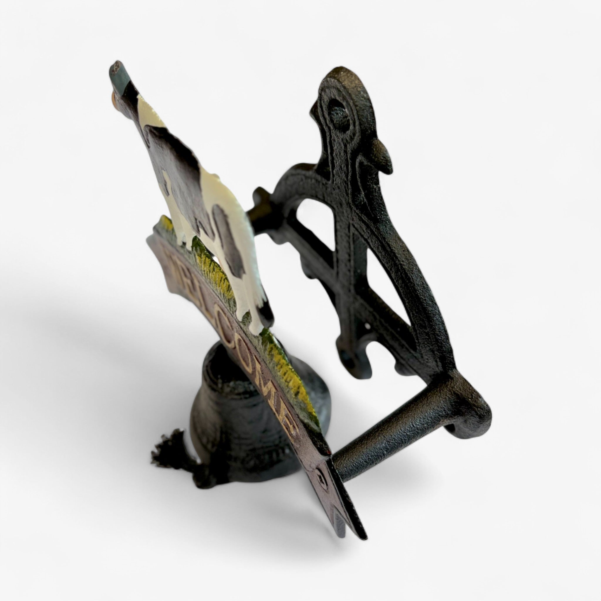 Cast iron cow welcome sign side view with black painted cow, leather strap, and decorative bell