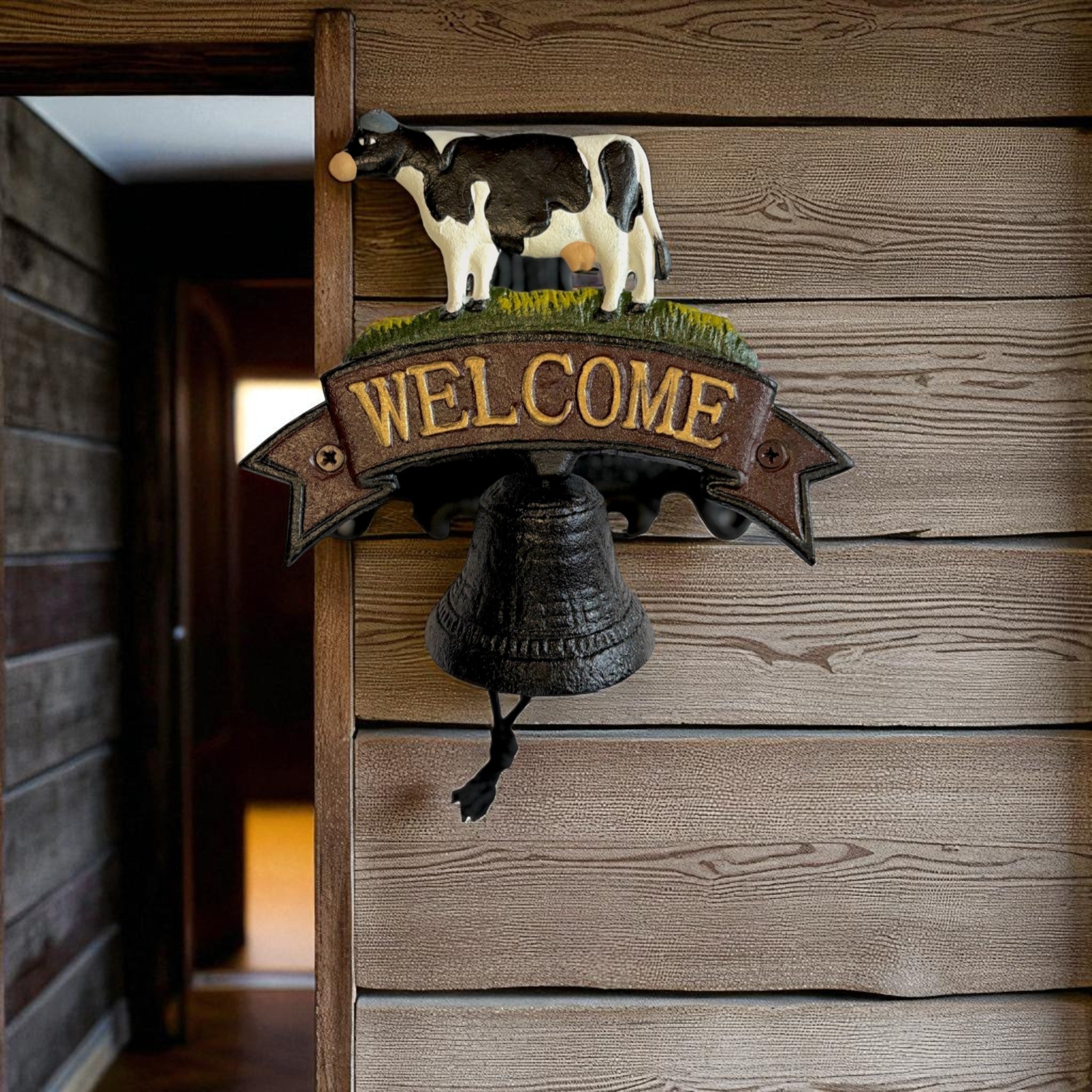 Rustic cast iron cow welcome bell sign with black and white painted finish and brass welcome banner