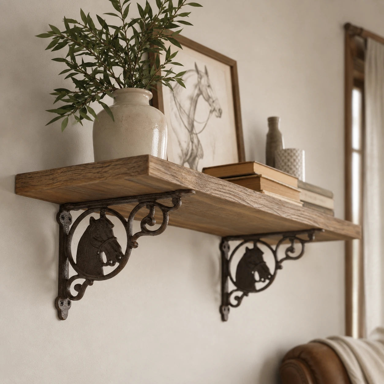 Rustic wall shelf with brown cast iron horse brackets and equestrian decor