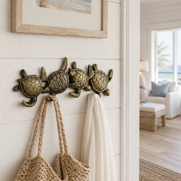 Cast iron sea turtle wall rack with four hooks.