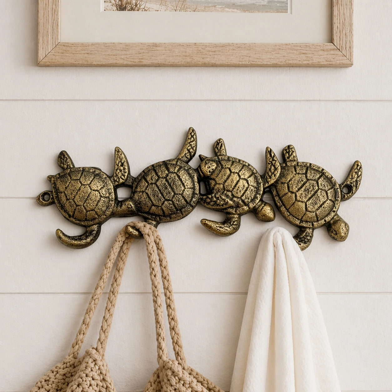 Sea turtle cast iron hook rack mounted on white shiplap.