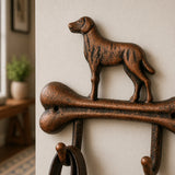 Close-up of a cast iron dog bone wall hook with leash.