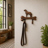 Cast iron dog bone wall hook displayed on a light wall.
