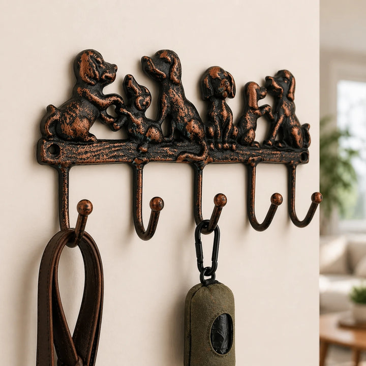 Cast iron dog family five-hook rack holding leashes and a key fob.