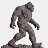 Bigfoot doorbell rustic cast iron sasquatch figure bell on weathered wood porch mounting