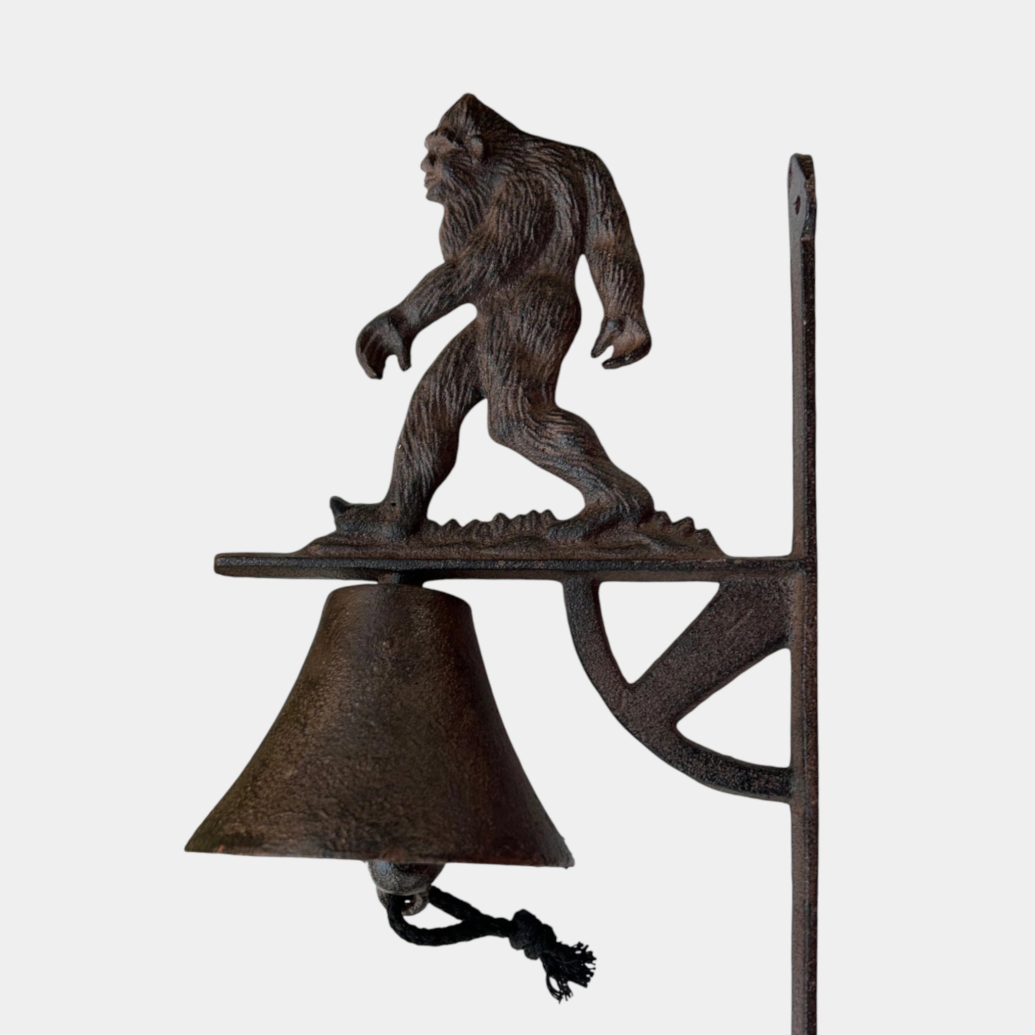 Sasquatch cast iron porch bell with detailed sculptural form and traditional bracket hardware