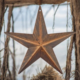 Brushed bronze barn star metal wall decor hanging from rope with rustic wood frame