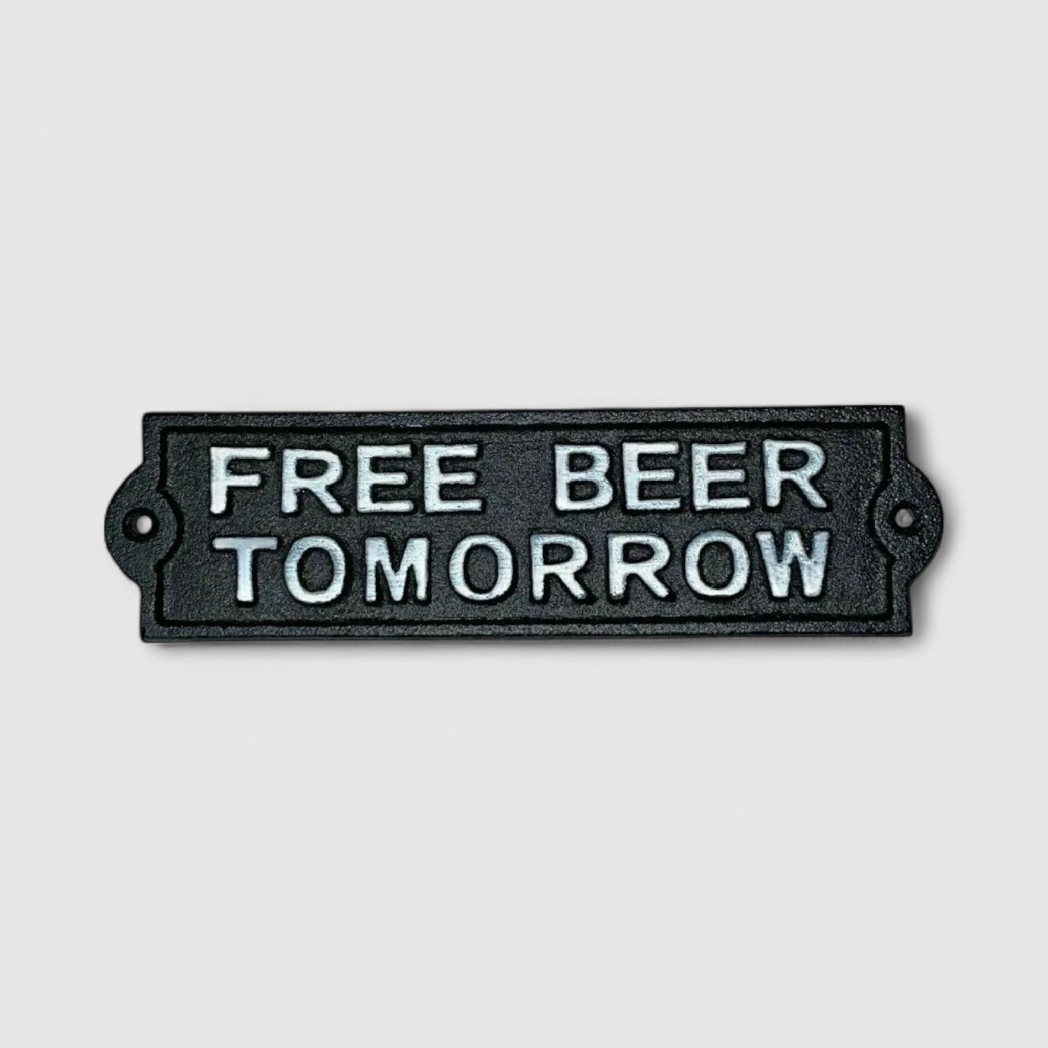 Black cast iron Free Beer Tomorrow plaque closeup, embossed white text, vintage humor sign