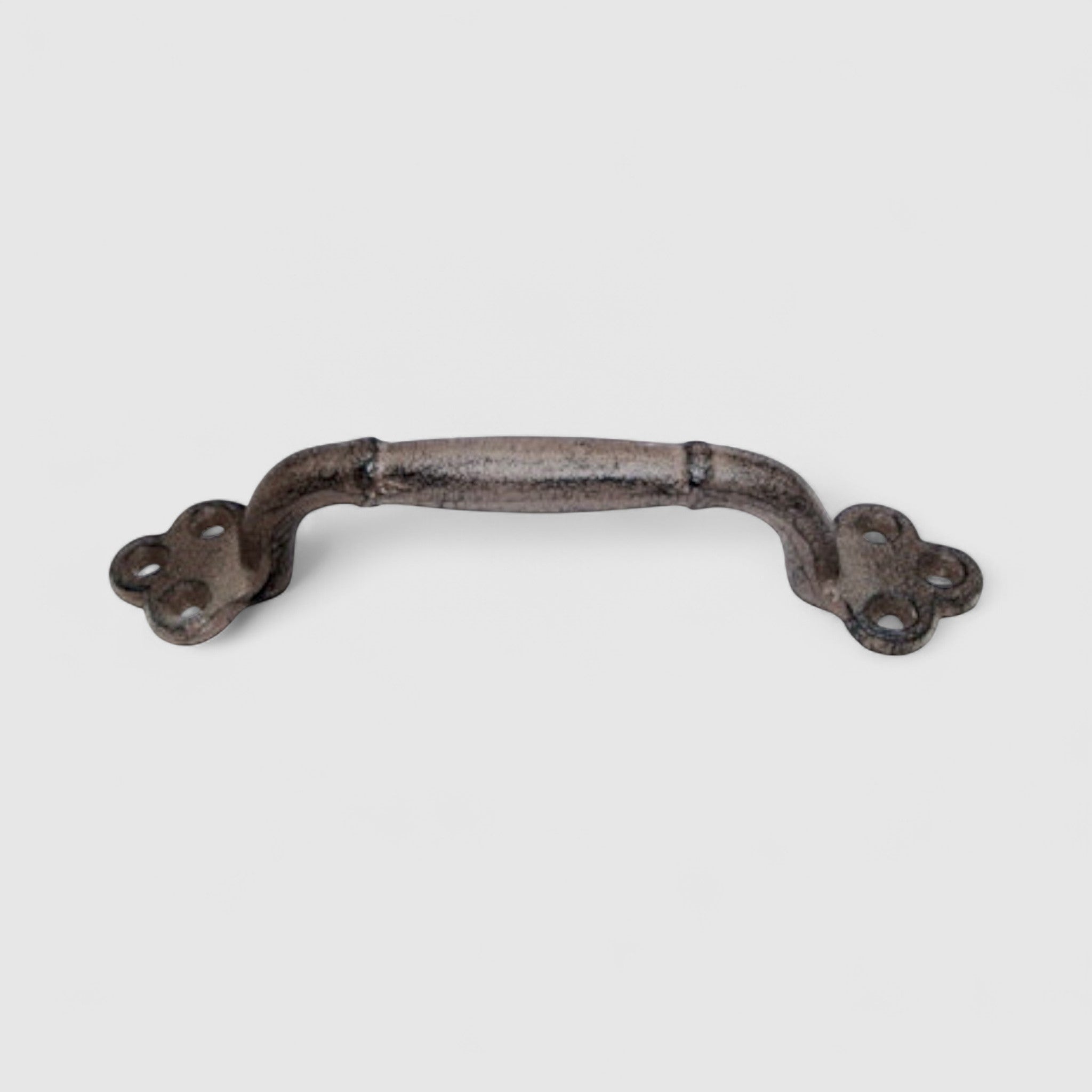 Large cast iron door pull hardware with decorative floral end plates, aged patina finish