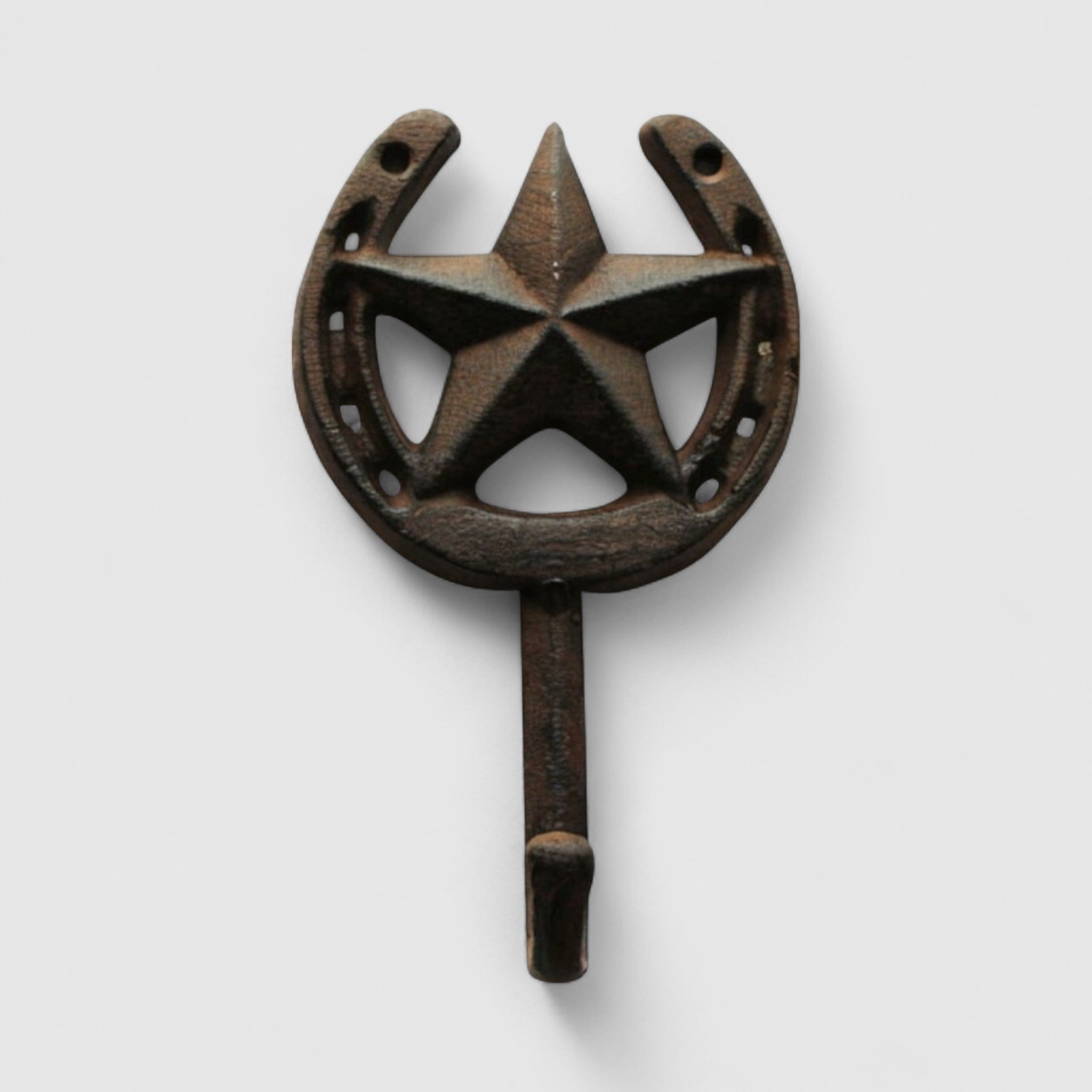 Dark aged cast iron star and horseshoe wall hook on white shiplap, functional decor