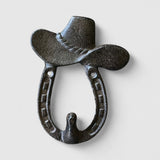 Rustic cast iron hat hook with horseshoe design, mounted on weathered wood wall