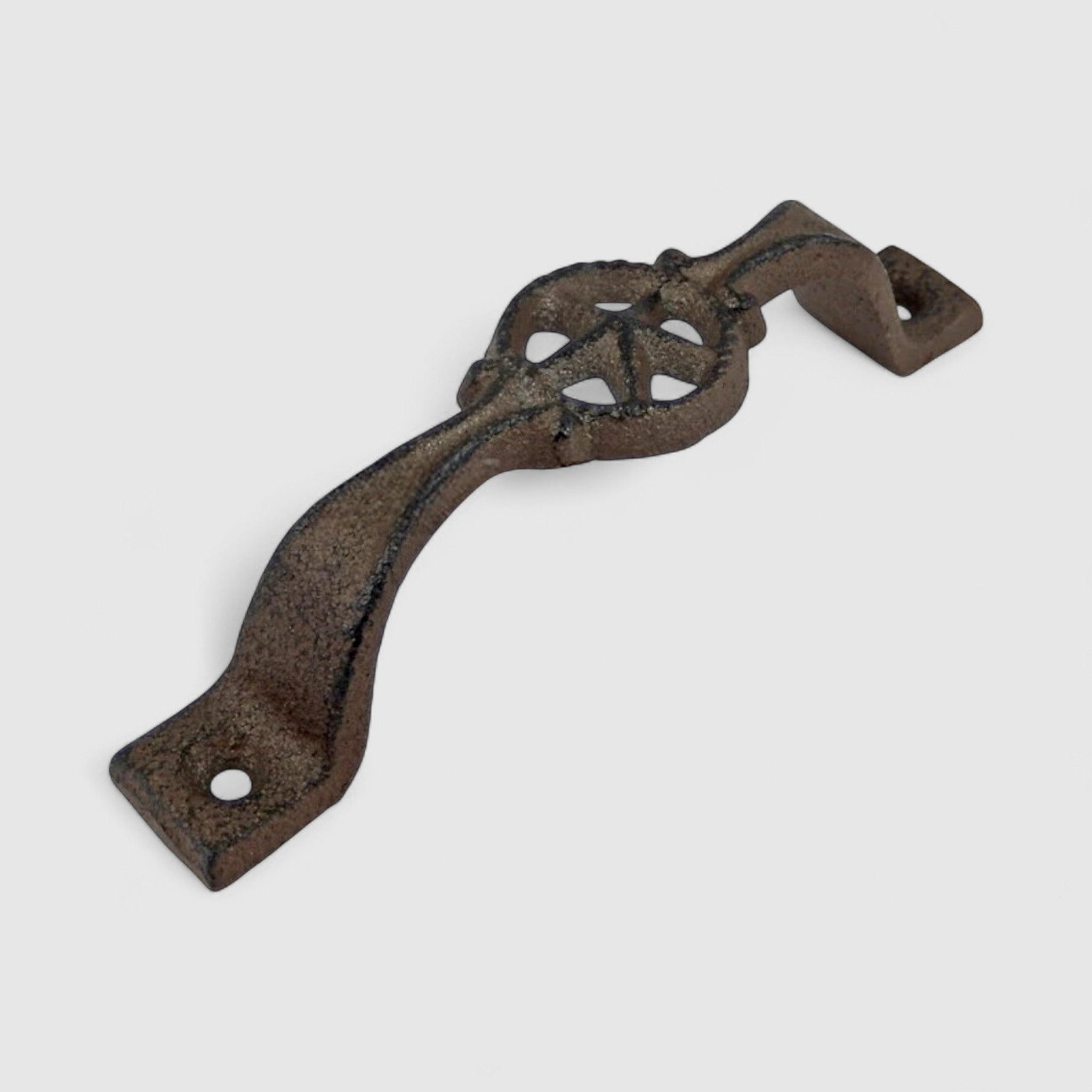 Ornate cast iron star handle on vintage blue-green barn door, farmhouse hardware accent