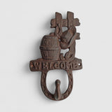 Black cast iron barrel hook wall hanging with welcome sign and towel rail