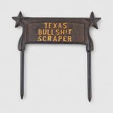 Cast iron boot scraper display showing star handles, Texas text detail, dark brown patina finish